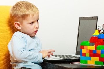 Fototapeta na wymiar little boy using laptop pc computer at home