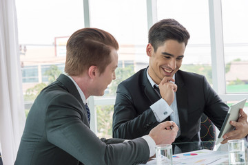 Two businessman dicussing business in office