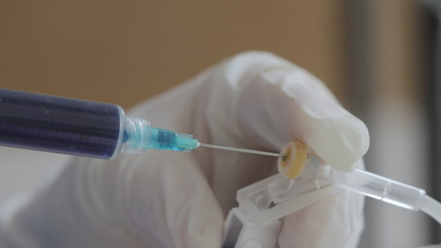 Injecting Blue Serum Into IV
