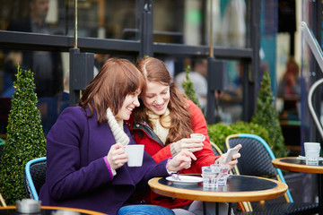 Two girls making self picture (selfie)