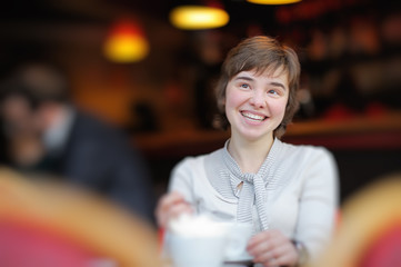 Happy young girl in a cafe