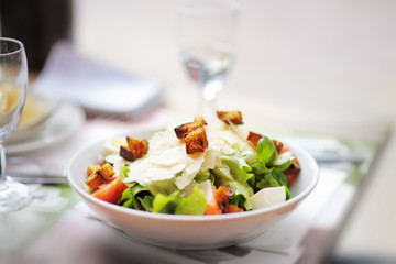 Salad with parmesan cheese and croutons, chicken and tomato