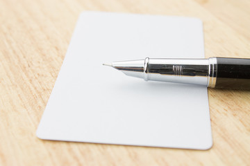 Blank business card and pen on a desk