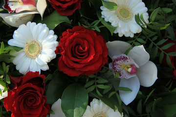 Cymbidium orchids, red roses and white gerberas