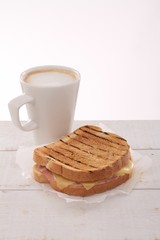 toasted cheese and ham sandwich with coffee