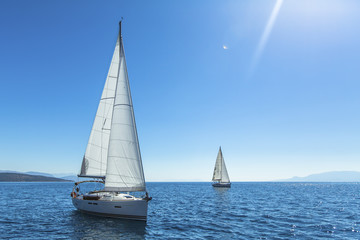 Fototapeta na wymiar Sailing. Yachting. Ship yachts with white sails in the open sea.