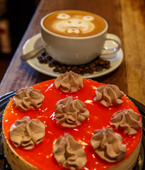 red cake with coffee cup in wooden table