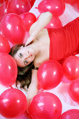 girl lying in balloons