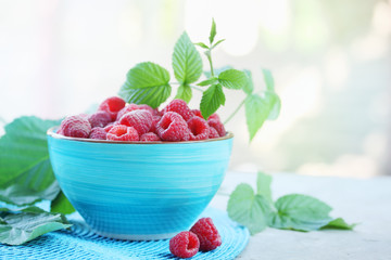 raspberry in a turquoise bowl