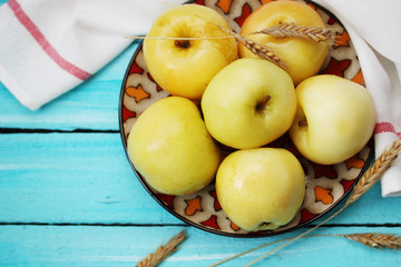 Pickled apples on a blue board, top view