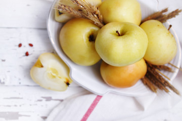 Rural apples on a white table, top view