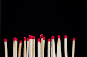 many red matches on black background