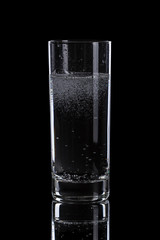 mineral water in simple highball glass, on black