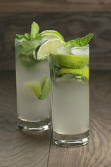 two mojito cocktails on old oak table