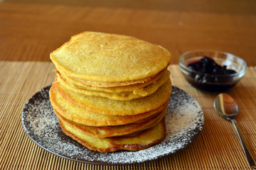 Fototapeta na wymiar Stack of sweet pancakes with strawberry and icing sugar