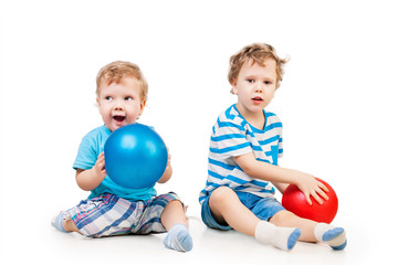 Fototapeta na wymiar Cute siblings playing with balls isolated on white