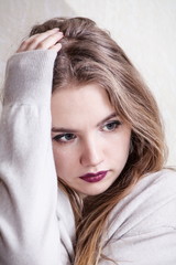 Young beautiful blonde girl is sad.