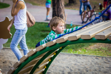 Fototapeta na wymiar little boy playing on the Playground