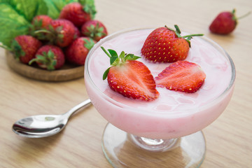 Yogurt with strawberry in glass