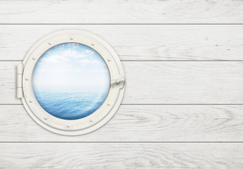 ship window or porthole on white wooden wall with sea or ocean