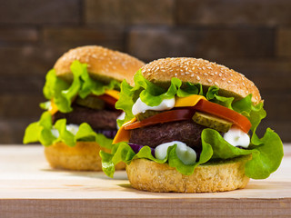 Big burger with beef cutlet and fresh vegetables