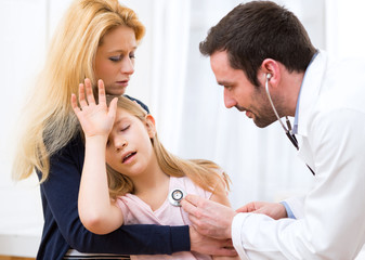 Doctor listening heart beatment of little girl