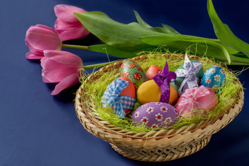 Basket with Easter eggs and tulips