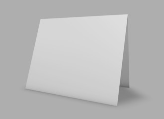 Blank calendar standing on floor, grey background.
