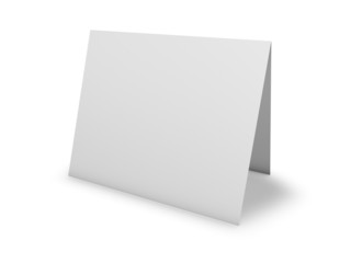 Blank greeting card standing on floor, isolated on white.