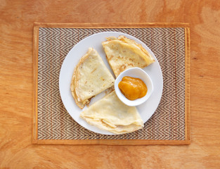 Crepes with mango jam on mat