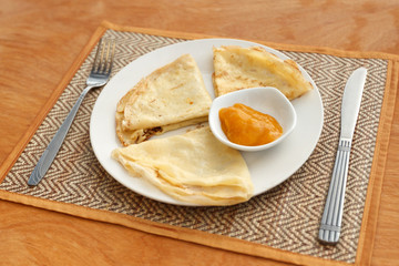 Crepes with mango jam on mat
