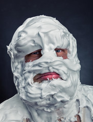 Crazy man with face completely in shaving foam