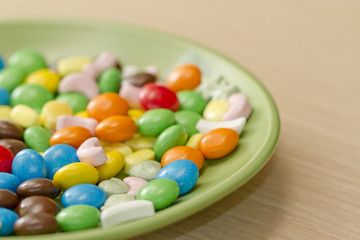 Colorful candy lying on saucer