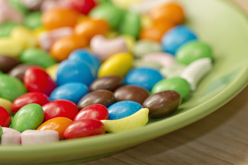 Colorful candy lying on saucer