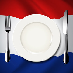 White plate with knife and fork on Netherlands flag background.