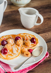 pancakes with cherry, raspberry and vanilla sauce