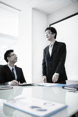 Businessman standing in front of colleagues during a meeting