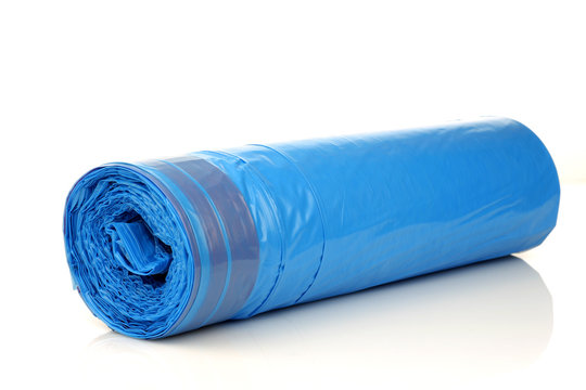 roll of blue garbage bags on a white background