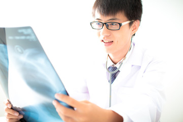 close up of male doctor holding x-ray or roentgen image