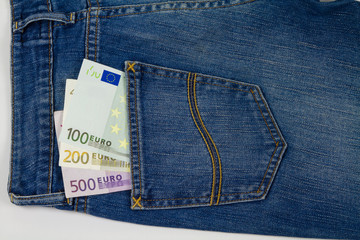 Euro money in a blue jeans pocket