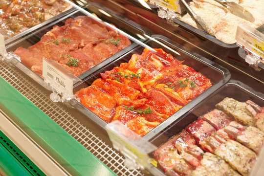 Meats in marinade on supermakket display