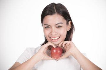 Smiling woman with apple isolated on white