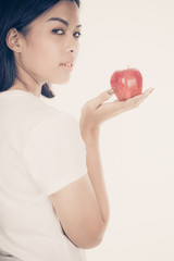 Smiling woman with apple isolated on white