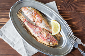 Fried red mullet on the oval dish