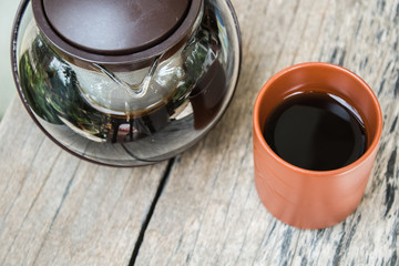 black tea in kettle and Clay cups