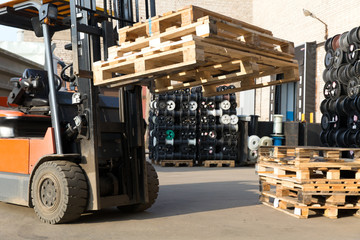 Factory Forklift Truck Stacker Transporting Pallets at Warehouse