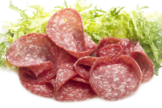 Salami sliced and bread with lattuce on white