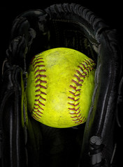 Old softball in a glove