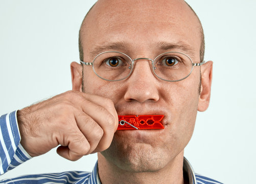 Man with mouth tightly closed