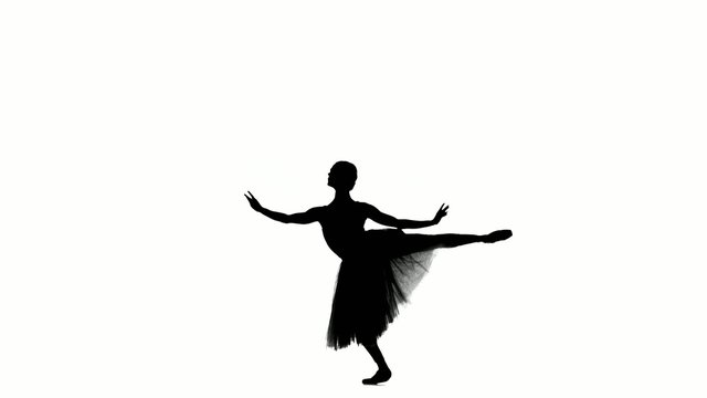 Attractive ballerina making dance trick, on white background